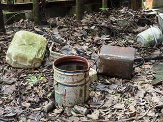 Cans and garbage lying on ground