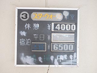 Room rate sign in carport of Hotel New Royal