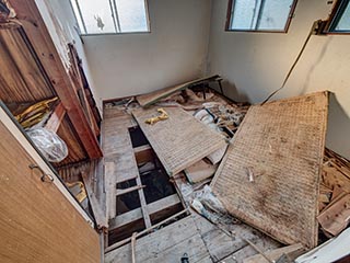 Upstairs room in manager's house of Hotel Penguin Village, with hole in floor