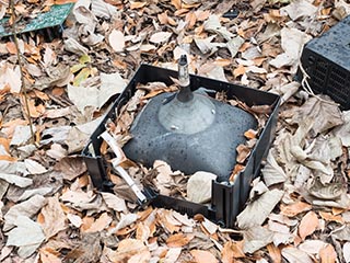 Broken TV lying amongst fallen leaves