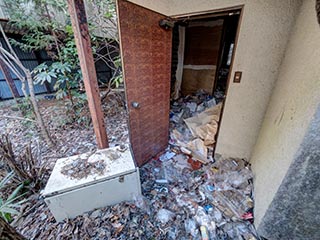 Garbage filled cottage at abandoned love hotel Century