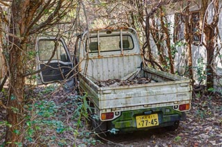 Abandoned truck in carpark of abandoned love hotel Century