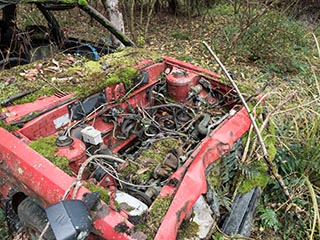 Engine bay of abandoned Mazda