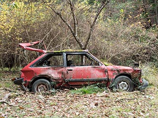 Abandoned Mazda in a field