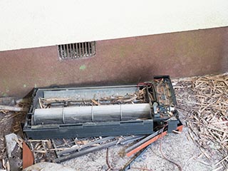 Broken air conditioner in carport at Motel Sun River