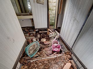 Rotten entry hall floor in Motel Sun River