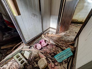 Rotten entry hall floor in Motel Sun River