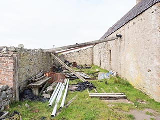 junk next to abandoned storehouse