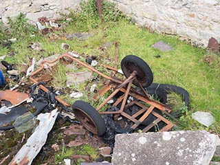 junk next to abandoned storehouse