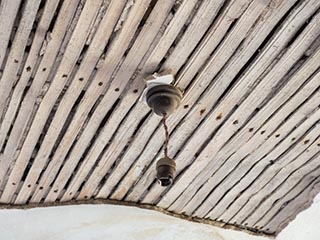 light fitting in ceiling with missing plaster