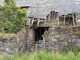 partially collapsed roof and wall