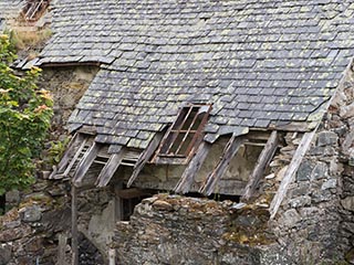 partially collapsed roof and wall