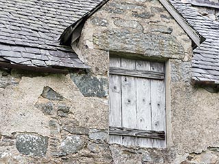 boarded window in ruined house