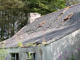 damaged roof of abandoned house