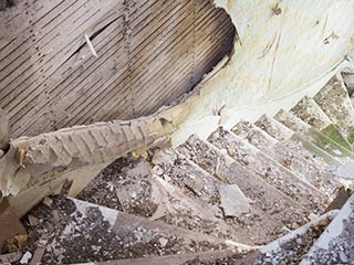 plaster crumbling onto stairs